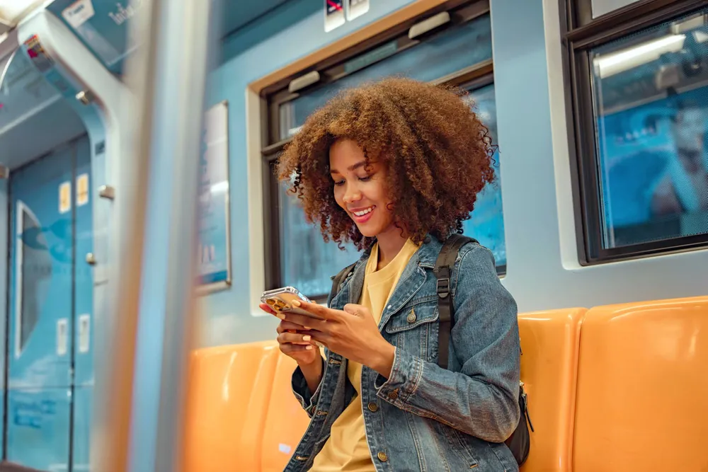 Woman on a train using her free phone from the government Lifeline program