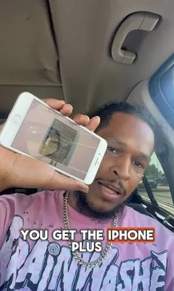 Free phone customer 12 holding the free smartphone they received