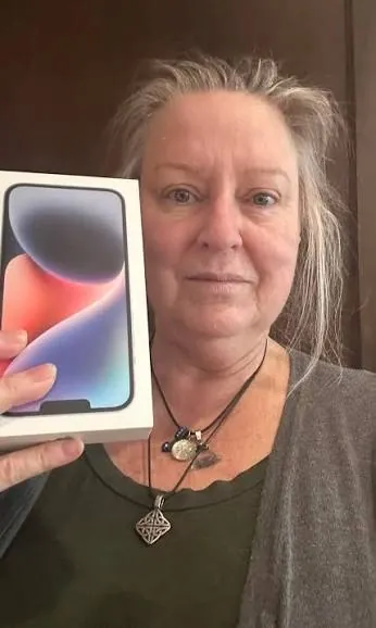 Free phone customer 16 holding the free smartphone they received